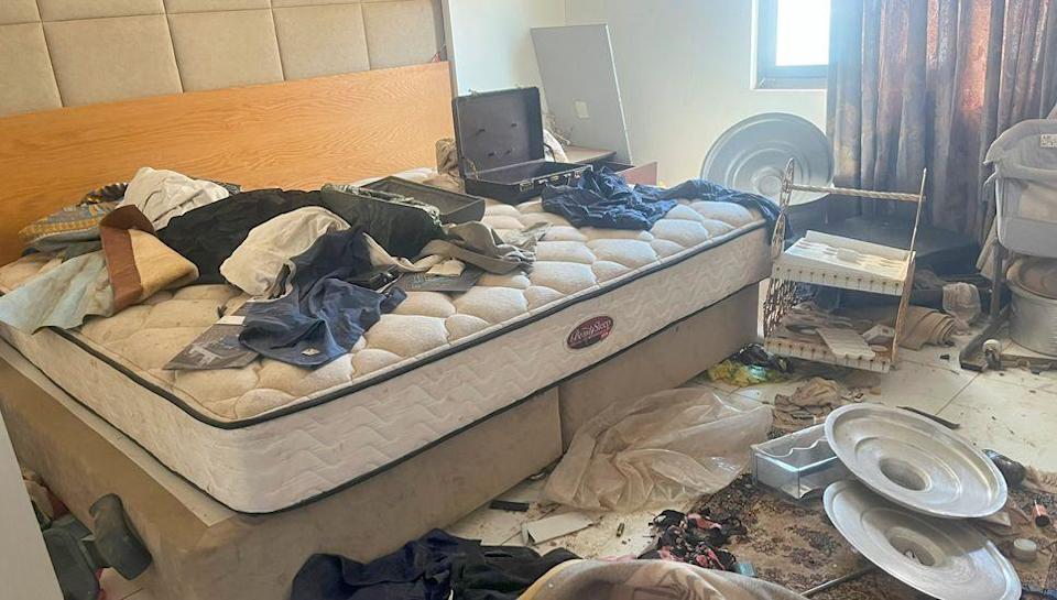 A room in Abdel Rahim Hamdan Dagalo&#39;s house in the upmarket Khartoum suburb of Karfuri  - showing clothes and a empty brief case on a bare mattress with pans and other things littered all over the floor.