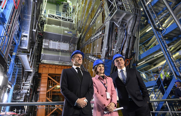 Emmanuel Macron, Fabiola Gianotti and Alain Berset pose in front of the ATLAS experiment at the CERN.