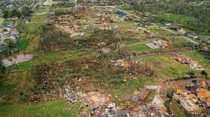 Trees splintered and homes destroyed after a tornado.