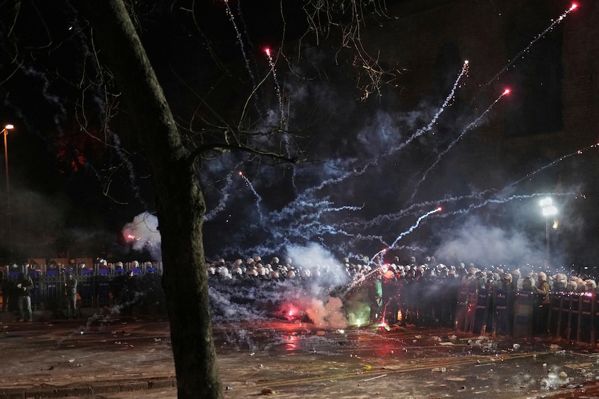 Fireworks over a crowd in the dark 