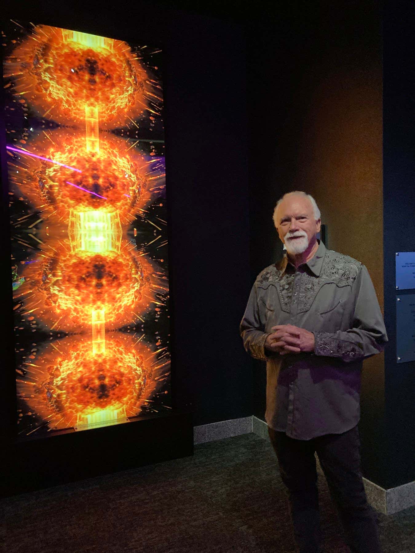 portrait of James next to installation of Spectre Fission