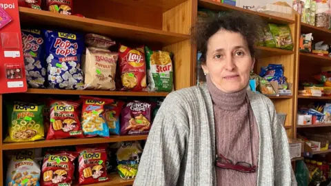 BBC/Sarah Rainsford Ionela in her shop in Poeni