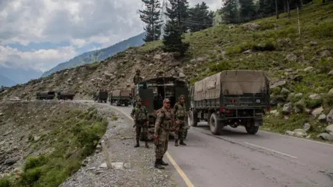 Getty Images Indian army convoy carrying reinforcements and supplies, drive towards Leh, on a highway bordering China, on September 2, 2020 in Gagangir, India