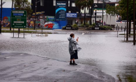 A woman on a flooded street in Lismore this month