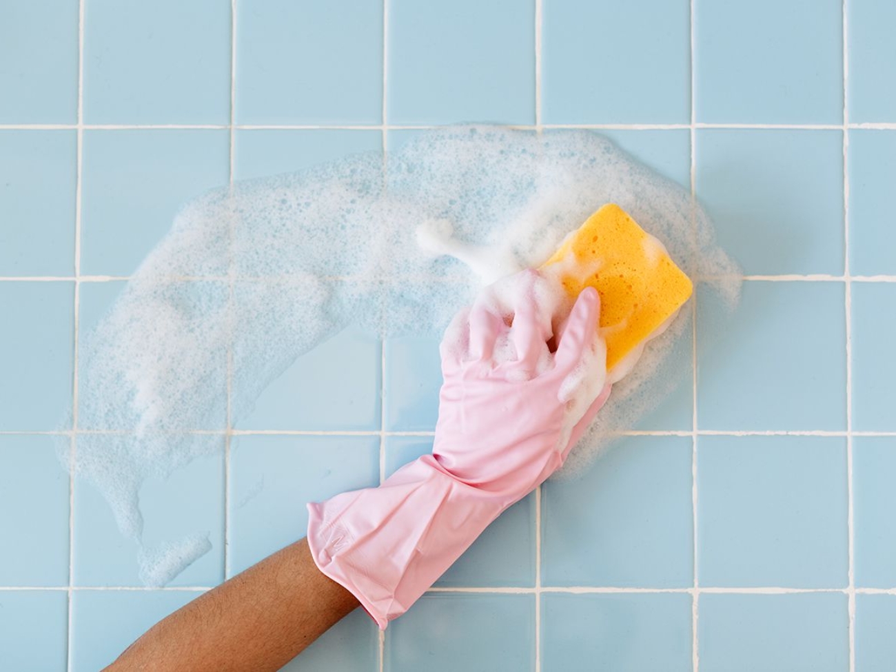 woman-cleaning-blue-tile-bathroom-getty-0420-44afb7530b3b4d9ab7e9704cd75309fb.jpg